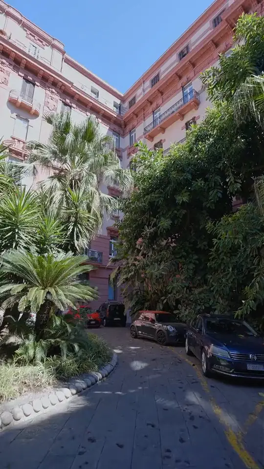 Il cortile del palazzo, l'ingresso con il logo e le sale dello studio